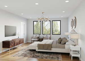 Bedroom featuring wood-type flooring, multiple windows, and a chandelier