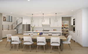 Kitchen featuring white cabinets, light hardwood / wood-style floors, decorative backsplash, stainless steel oven, and a spacious island