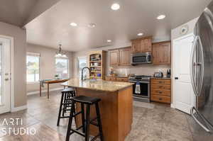 Spacious kitchen with pantry, granite countertop island, and stainless steel appliances