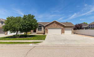 Front view of 3 car garage home with gravel RV pad