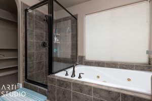 Primary ensuite bathroom. Garden tub and shower with window providing view of the backyard