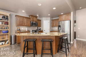 Spacious kitchen with pantry, granite countertop island, and stainless steel appliances