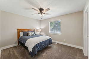 Master Bedroom, carpeted, with a textured ceiling and ceiling fan