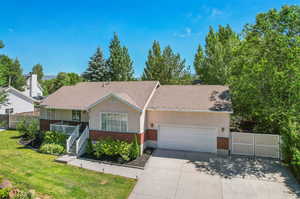 View of front of home with a garage and a front lawn