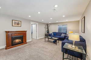 Carpeted living room featuring a textured ceiling