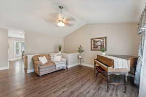 Interior space with wood-type flooring, ceiling fan, and lofted ceiling