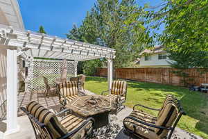 View of patio with a pergola and a fire pit