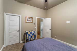 Bedroom with light carpet and ceiling fan