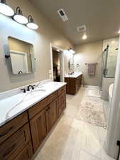 Bathroom featuring plus walk in shower and vanity