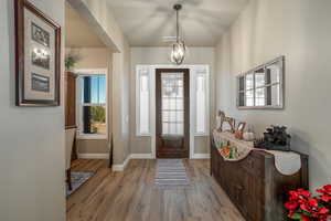 Entryway featuring a notable chandelier and light hardwood / wood-style floors