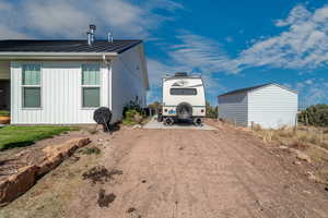 View of side of home with an outbuilding