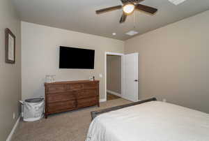 Carpeted bedroom with ceiling fan