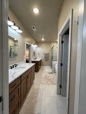 Bathroom featuring vanity and a shower with shower door