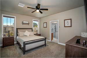 Bedroom with carpet, ensuite bath, and ceiling fan