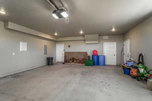 Garage featuring a garage door opener and electric panel