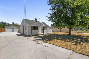 View of front of home featuring a garage and an outdoor structure