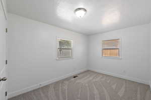 Empty room featuring carpet flooring