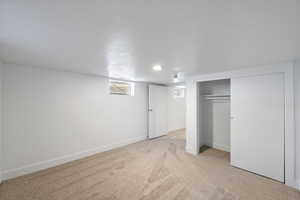 Unfurnished bedroom with a closet and light colored carpet