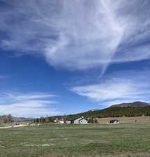 View of community featuring a lawn, a mountain view, and a rural view