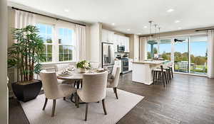 Dining room featuring sink, ceiling fan, and LVT flooring.Materials and color features selected may vary; these are pictures of a model home.