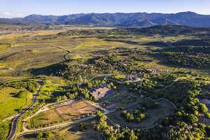 Aerial view of property's location featuring a mountainous background