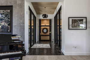 Hall featuring baseboards and wood finished floors