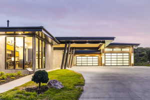 Contemporary home with concrete driveway and a garage
