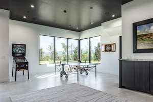 Game room with healthy amount of natural light, baseboards, recessed lighting, and light tile patterned floors