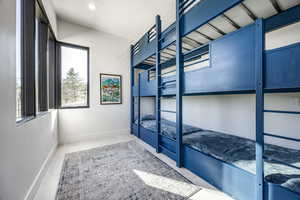Unfurnished bedroom featuring multiple windows, baseboards, and recessed lighting