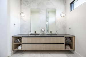 Bathroom with baseboards and double vanity