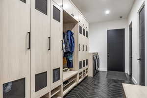 Mudroom featuring washer and clothes dryer and baseboards