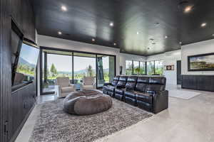 Living area featuring recessed lighting and wooden walls