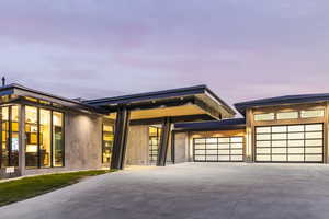 Contemporary home featuring concrete driveway and a garage