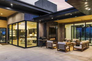 View of patio / terrace with an outdoor living space with a fireplace