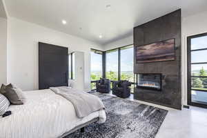 Bedroom with access to exterior, a fireplace, and recessed lighting