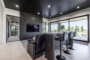 Cinema featuring bar area, recessed lighting, and baseboards