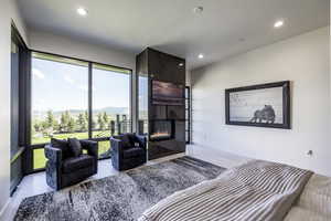 Living room featuring a large fireplace and recessed lighting
