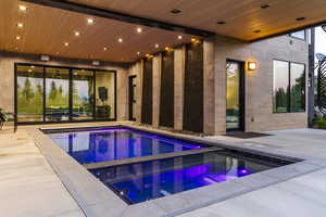 View of swimming pool with an in-ground hot tub and a patio