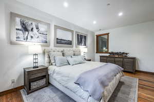 Bedroom featuring baseboards, wood finished floors, and recessed lighting