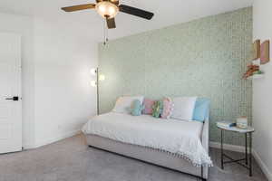 Carpeted bedroom with ceiling fan