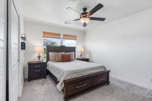 Bedroom with light carpet and ceiling fan