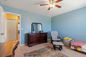 Interior space with carpet floors and ceiling fan