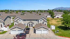 View of front facade with a garage and a mountain view