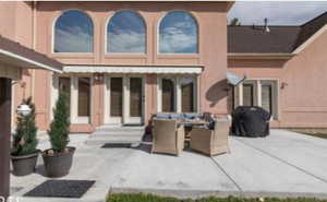 Rear view of house with a patio area and BBQ