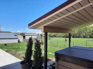 View of fenced horse pasture, corral, and barn extension