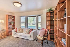 Spacious front office/bedroom with multiple bookcases and bay window