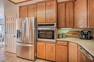 Custom oak kitchen, complete with newer cookware, glassware, dishware, flatware, bakeware, cooking utensils, stainless mixing bowls, and more.