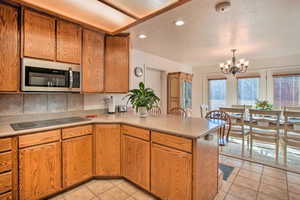 Highest quality custom oak cabinetry with newer stainless appliances, and fully stocked dishes and cookware.