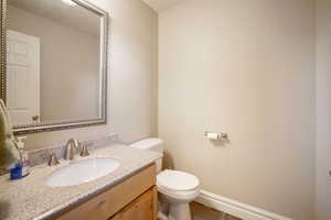 Bathroom featuring tile patterned floors, vanity, and toilet