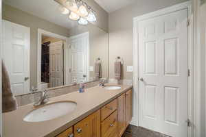 Bathroom featuring double vanity and tile patterned floors